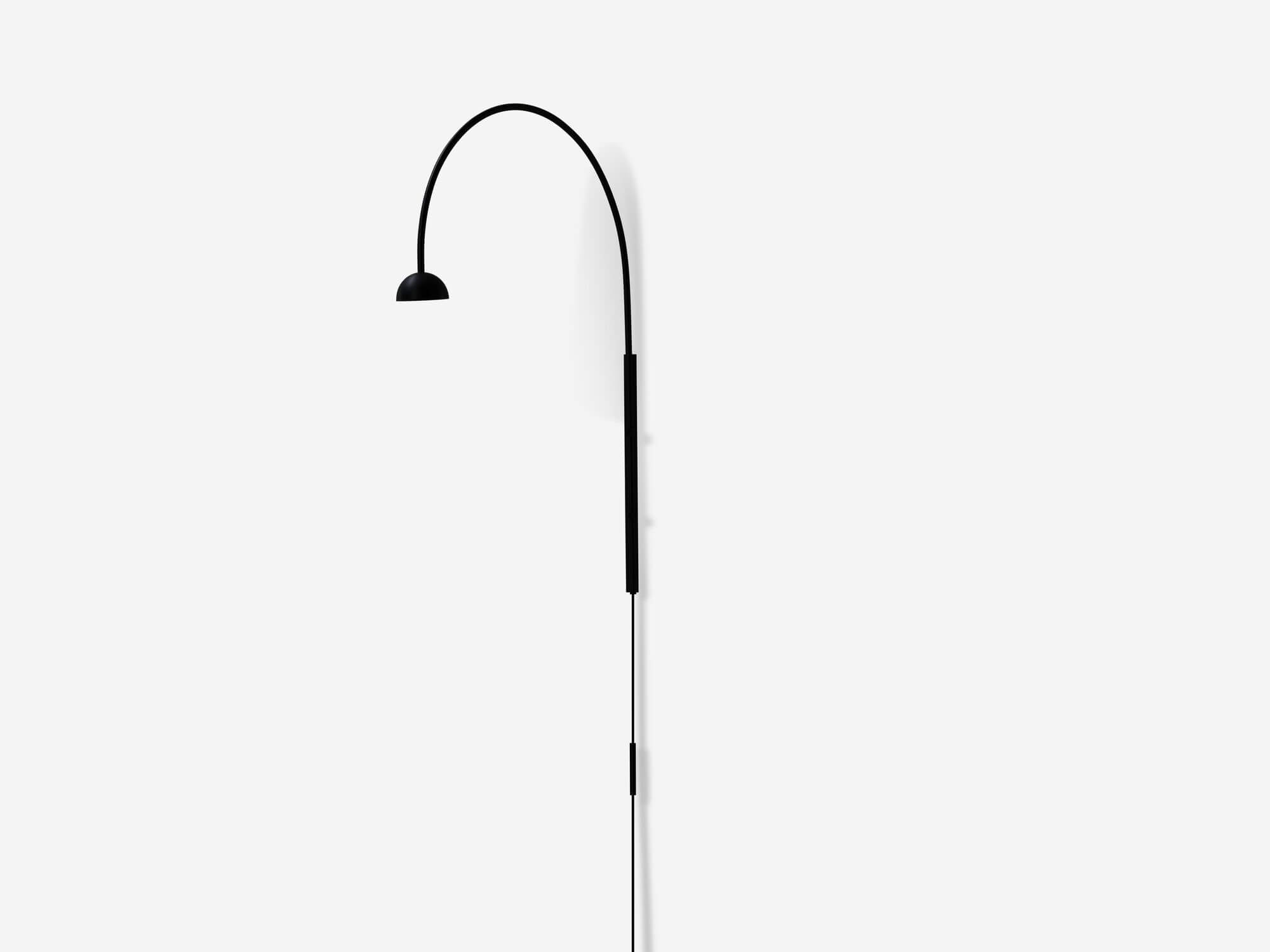 Front angle view of black arched wall lamp